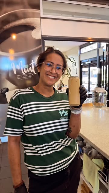 A smiling barista at Mint